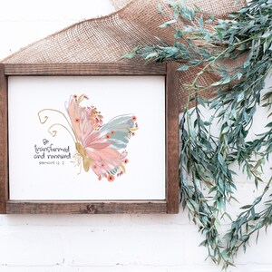 May include: A framed print with a watercolor butterfly design and the text "Be transformed and renewed" Romans 12:2.