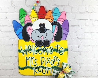 Welcome students with this cute back to school wooden door hanger featuring a dog and brightly colored crayons. PREORDER brand new design!