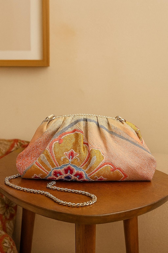 Handcrafted Dumpling Clutch with Arabesque Flower and Rhombus Pattern – Elegant Pink and Gold Bag