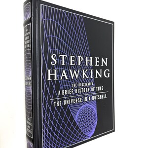 May include: A black hardcover book titled Stephen Hawking The Illustrated A Brief History of Time and The Universe in a Nutshell. The cover features white text and a purple grid pattern design. The spine also displays the book titles in white text.
