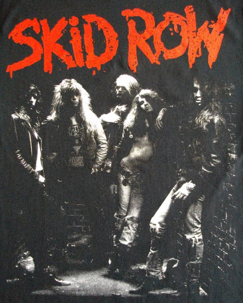 May include: Black and white photo of a rock band, Skid Row, with the band name in red letters above them.