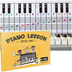 May include: A yellow book titled "Piano Lesson - Book One" with a complete piano lesson and guide for beginners. The cover features a cartoon illustration of children playing a keyboard.