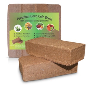 May include: Two brown coco coir bricks stacked on top of each other. The bricks are made from 100% compressed coconut and are ideal for starting plants. The packaging shows the text "Premium Coco Coir Brick" and "100% Compressed Coconut Starting Mix".