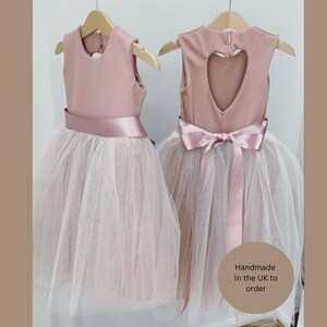 Blush pink glittery tutu flower girl dress with a heart back ankle length hand made in the UK.
Girls princess tutu dress