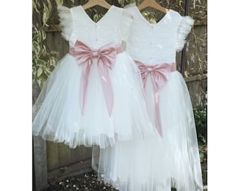 Hand made long length lace tutu dress with a large satin bow sash and pearl buttons