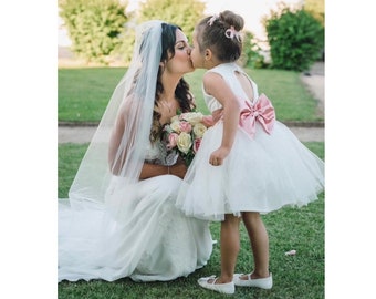 Handmade sparkly tulle heart back with a pink satin bow flower girl dress