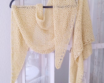 May include: A pale yellow crocheted shawl hanging on a heart-shaped hanger. The shawl is draped over a white wooden screen with a small card that reads "I must have flowers always near".