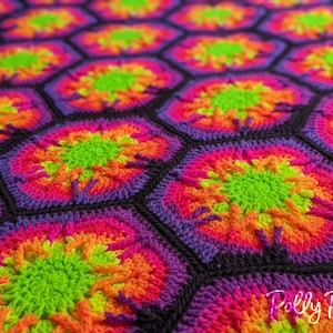 May include: A colorful crochet blanket with a hexagonal pattern. The blanket is made with bright pink, orange, yellow, green, and purple yarn. The center of each hexagon features a green circle.