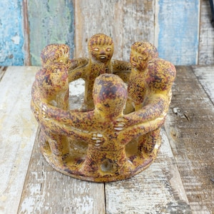 May include: A trio of ceramic mugs with a speckled, matte finish in cream, light grey, and dark grey. Each mug features a minimalist design and a rounded handle.