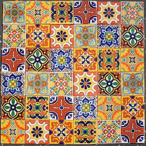 May include: A grid of thirty-six square ceramic tiles featuring a variety of colourful, intricate floral and geometric patterns in shades of yellow, orange, red, blue, green, and white, arranged in a repeating mosaic display of distinct designs.