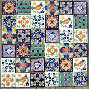 May include: A collection of 30 square ceramic tiles with colourful, intricate designs. The tiles feature floral patterns, birds, and geometric shapes in shades of blue, orange, yellow, and green. The tiles are arranged in a grid pattern.