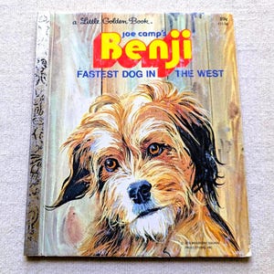 May include: A vintage Little Golden Book titled "Benji Fastest Dog in the West." The cover features a detailed illustration of a brown and white dog with expressive eyes. The title is in large yellow and red letters.
