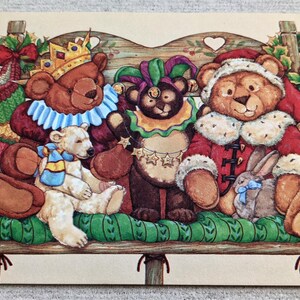 May include: A whimsical illustration featuring several anthropomorphic bears and a polar bear, each adorned in festive attire. One bear wears a crown, another a jester's collar, and a third a Santa suit. A rabbit with a blue bow is also present.