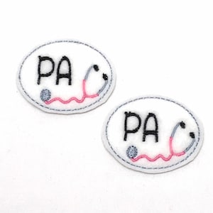 May include: Two white oval embroidered patches with the letters "PA" and a pink and gray stethoscope.