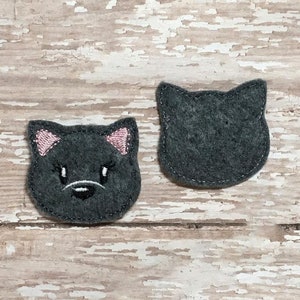 May include: Two felt cat appliques, one with a black face and pink ears, the other with a simple black outline.