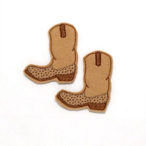 May include: Two brown felt cowboy boot appliques with brown stitching.