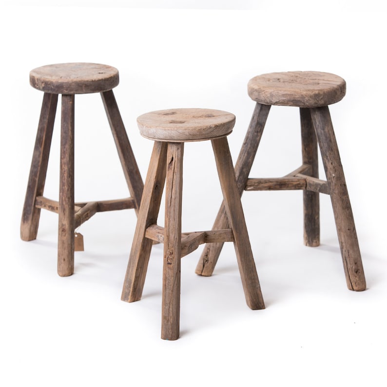 Three leg rustic old wooden stools are charming and perfect in any French farmhouse or European country design scheme. #threelegs #stools #rusticdecor