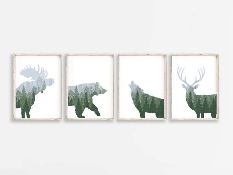 May include: Four framed art prints featuring forest animal silhouettes: a moose, bear, wolf, and deer. Each animal is filled with a green and gray forest scene. The prints have a white background and are in light wood frames.