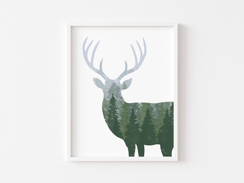 May include: A framed art print featuring a deer silhouette with a forest scene integrated into its form. The deer's antlers are a light blue-gray, and the forest is rendered in shades of green and gray. The artwork is set against a white background.