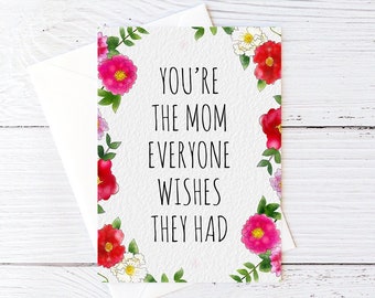May include: A white card with pink and white flowers around the border. The card says "You're the mom everyone wishes they had".