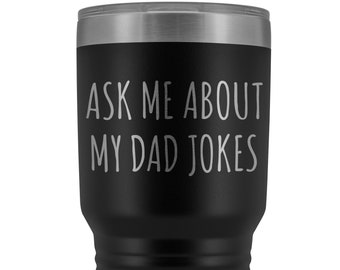 May include: Black stainless steel tumbler with a silver lid. The tumbler has the text "Ask me about my dad jokes" printed on the side.