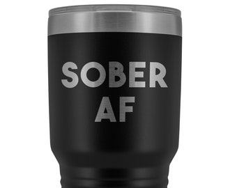 May include: Black stainless steel tumbler with a silver lid and the text "SOBER AF" in silver lettering.