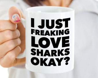May include: White ceramic mug with black text that reads "I just freaking love sharks okay?"