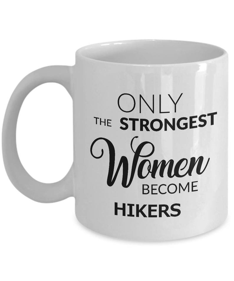 May include: White ceramic mug with a curved handle. The mug features the text "ONLY THE STRONGEST Women BECOME HIKERS" in black lettering. A perfect gift for hikers.