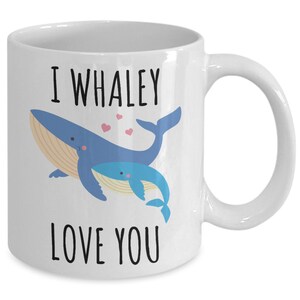 May include: White ceramic coffee mug with a blue whale and a baby whale illustration. The text "I whaley love you" is printed on the mug.