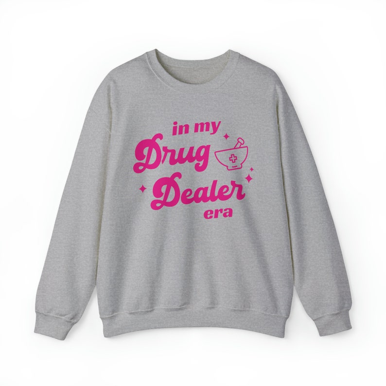 May include: A gray sweatshirt with a pink graphic that says "in my drug dealer era" with a mortar and pestle icon.