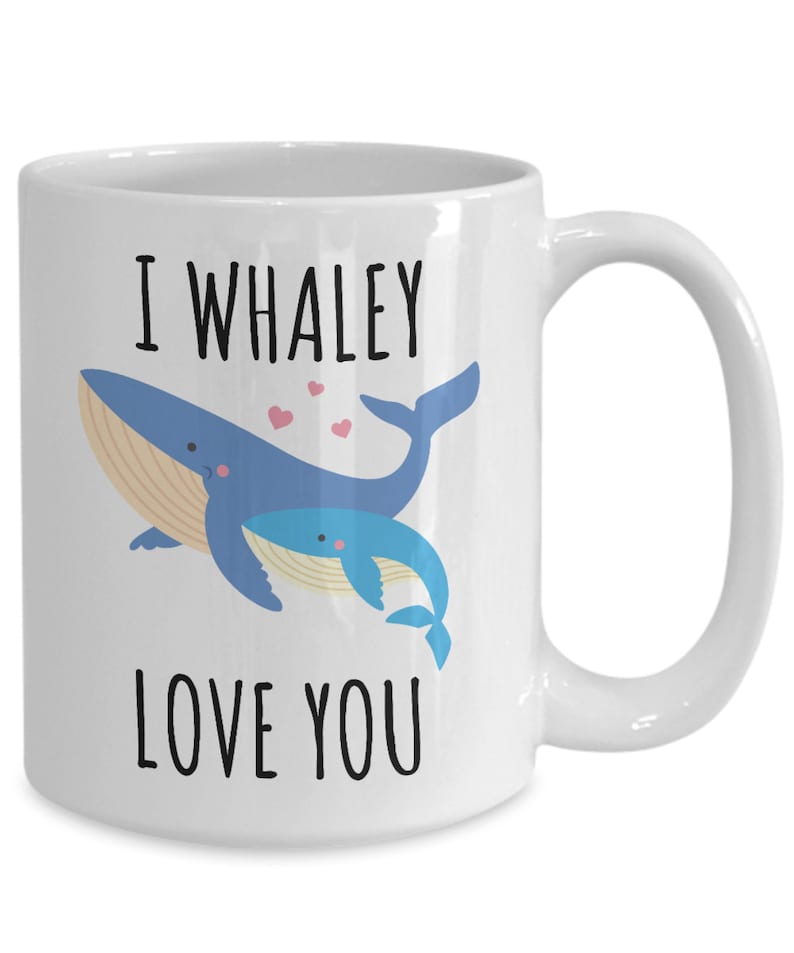 May include: White ceramic coffee mug with a blue whale and a baby whale illustration. The text "I whaley love you" is printed on the mug.