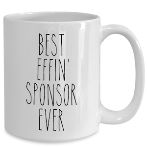 May include: White ceramic coffee mug with black text that reads "Best Effin' Sponsor Ever".