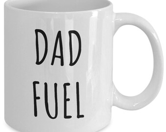 May include: White ceramic coffee mug with black text that reads "DAD FUEL".