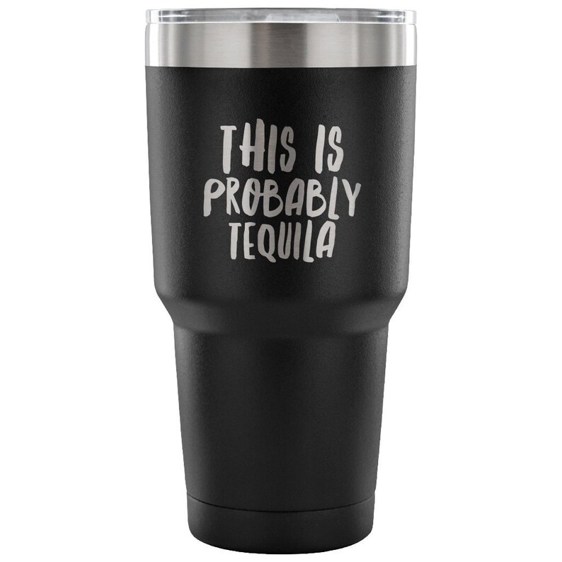 May include: Black stainless steel tumbler with a silver lid and the text "This is probably tequila" in white.