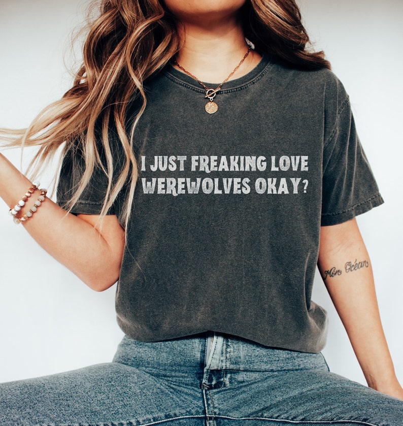 May include: A dark gray t-shirt with the text "I JUST FREAKING LOVE WEREWOLVES OKAY?" printed in white.