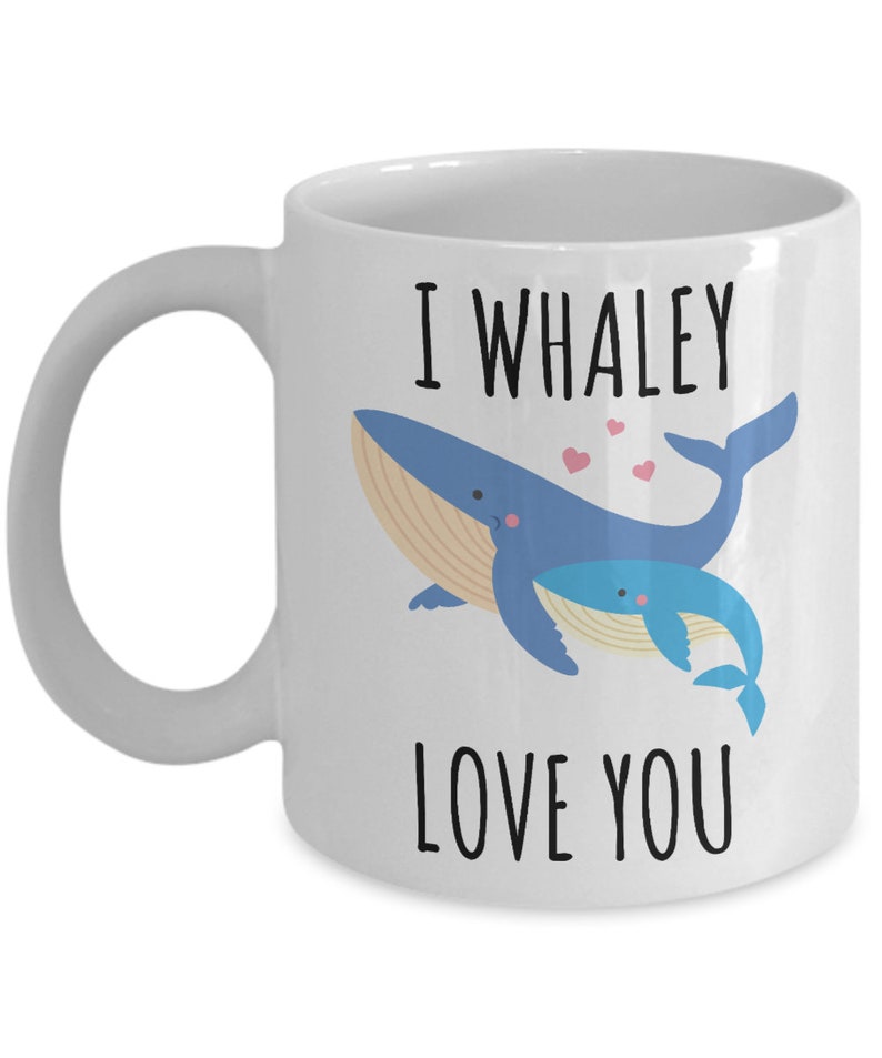 May include: White ceramic coffee mug with a blue whale and a baby whale illustration. The text on the mug reads "I whaley love you".