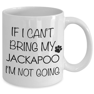 May include: White ceramic coffee mug with black text that reads "If I can't bring my Jackapoo I'm not going" with a paw print icon.