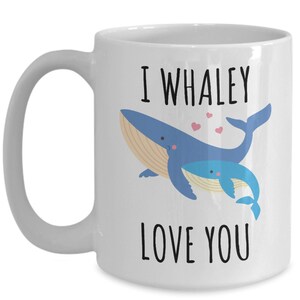 May include: White ceramic coffee mug with a blue whale and a baby whale illustration. The text "I whaley love you" is printed on the mug.