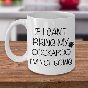 May include: White ceramic coffee mug with black text that reads "If I can't bring my Cockapoo I'm not going". A black paw print is next to the word "my".