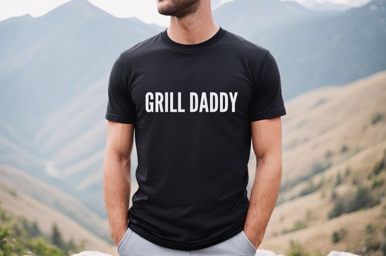 May include: A black t-shirt with the text "GRILL DADDY" printed in white on the front.