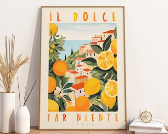 May include: A framed vertical art print featuring a coastal Italian village scene surrounded by bright yellow and orange citrus fruits and green leaves. The text IL DOLCE FAR NIENTE ITALY is printed in orange and yellow at the top and bottom.