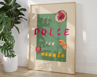 May include: A framed print with a green background and the text "IL DOLCE FAR NIENTE" in pink and yellow letters. The print features illustrations of a fig, a cherry, and an orange slice.