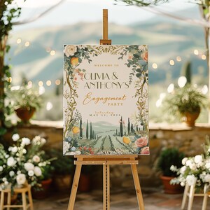May include: A welcome sign for Olivia & Anthony's engagement party, featuring a watercolor illustration of a Tuscan landscape with olive trees, lemons, and flowers. The text reads "Welcome to Olivia & Anthony's Engagement Party, Saturday, May 11, 2024".
