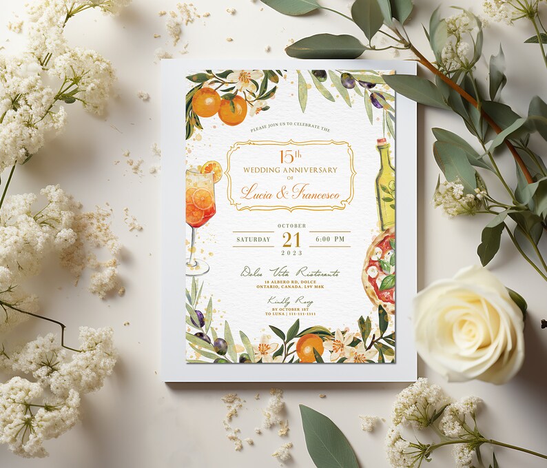 May include: A wedding anniversary invitation with a watercolor illustration of a glass of orange juice, a bottle of olive oil, a pizza, and orange blossoms. The text reads "Please join us to celebrate the 15th Wedding Anniversary of Lucia & Francesco, Saturday October 21, 2023, 6:00 PM, Dolce Vita Ristorante, 14 Albergo Rd, Dolce Ontario, Canada, L5V 1M8, Kindly RSVP by October 14th."