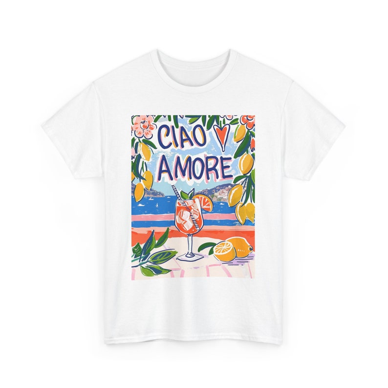 May include: White t-shirt with a colorful graphic print of a glass of orange juice, lemons, and the text "Ciao Amore".