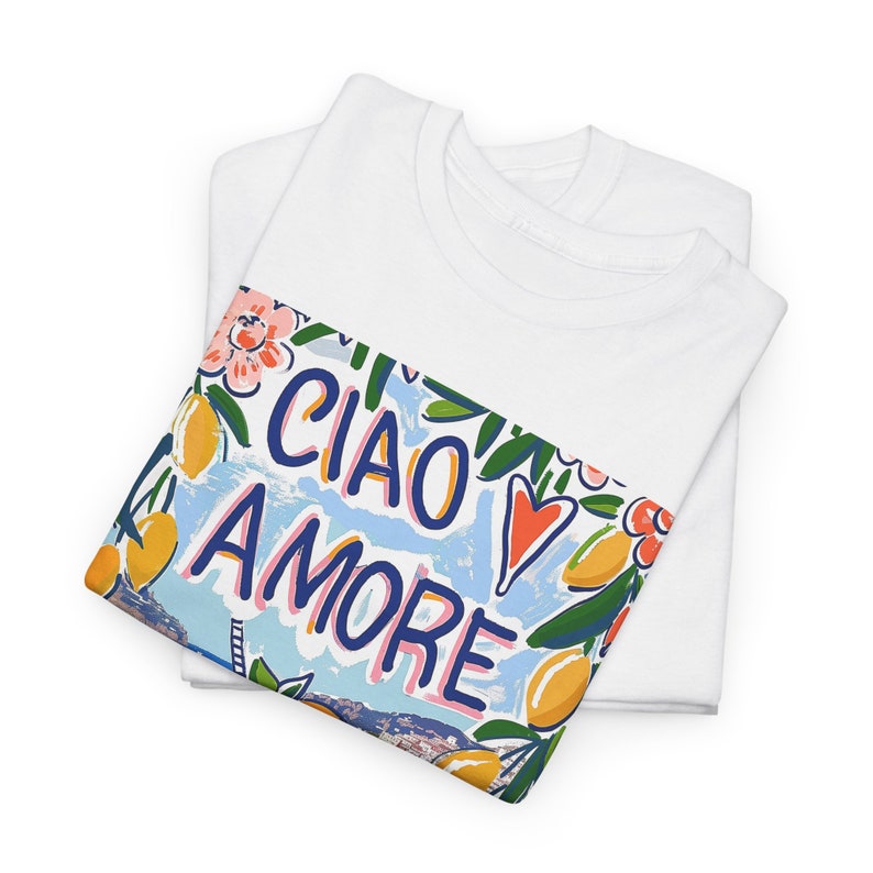 May include: White t-shirt with a colorful graphic print featuring lemons, flowers, and the text "Ciao Amore".