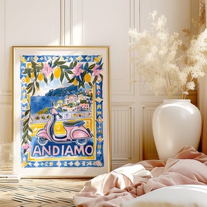 May include: A colorful illustration of a pink scooter with the text "ANDIAMO" in front of a blue and white tiled background. The scooter is in front of a scene of a coastal town with a lemon tree in the foreground.