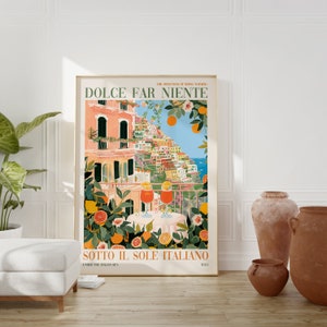 Op de afbeelding: Een kleurrijke illustratie van een stadsbeeld met gebouwen op een heuvel, een balkon met twee glazen sinaasappelsap en de tekst "DOLCE FAR NIENTE THE SWEETNESS OF DOING NOTHING SOTTO IL SOLE ITALIANO UNDER THE ITALIAN SUN ITALY".