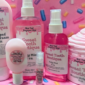 May include: A collection of pink body care products from Sweet Tooth Boutique, including whipped body cream, body mist, and a sample. The labels feature the Nose Food Fragrance Shop logo and product details.