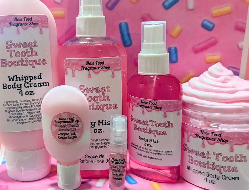 May include: A collection of pink body care products from Sweet Tooth Boutique, including whipped body cream, body mist, and a sample. The labels feature the Nose Food Fragrance Shop logo and product details.